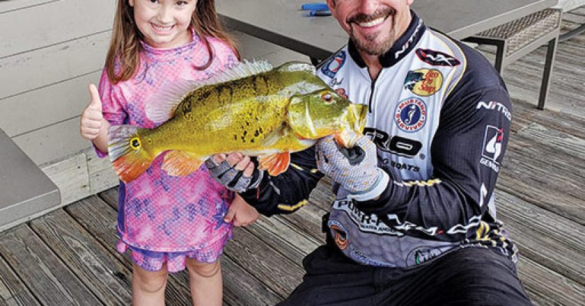 Five year old Kaylie Leavelle caught her first fish with a little help from Capt. Neal.