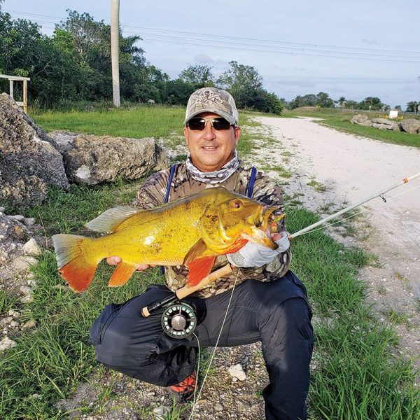 Tim Milan with a stud peacock bass caught on a fly.