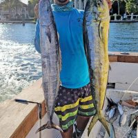 Loyal reader Chris Pascual with a wahoo and dolphin caught on a charter trip with Fishing Headquarters.