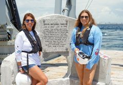 Johnny’s mother and sister, Jamie and Chloe Baker, in front of memorial plaque.