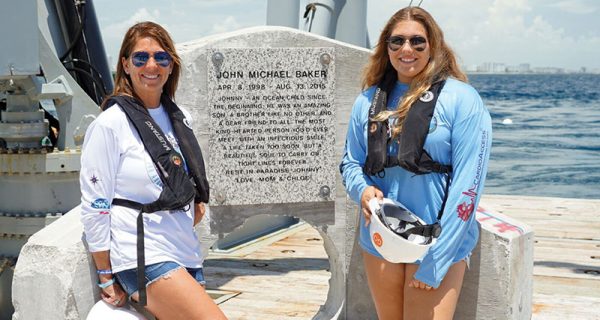 Johnny’s mother and sister, Jamie and Chloe Baker, in front of memorial plaque.