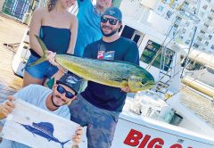 Happy couple with dinner and a sailfish release aboard the Big Game.