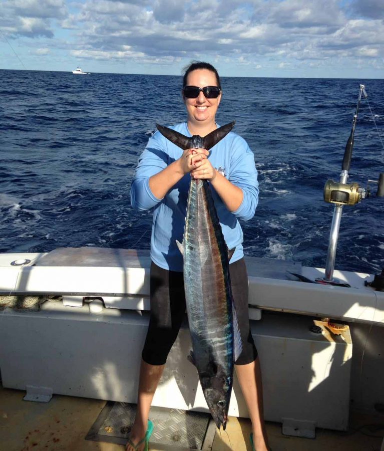 My wife, Arielle Kelly, on my first leisure day of the wahoo season, with a nice average size wahoo that she caught. PHOTO CREDIT: Capt. Travis Kelly.
