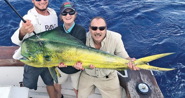 Alex, Pat and Dan with a monster bull dolphin caught fishing with Fishing Headquarters.