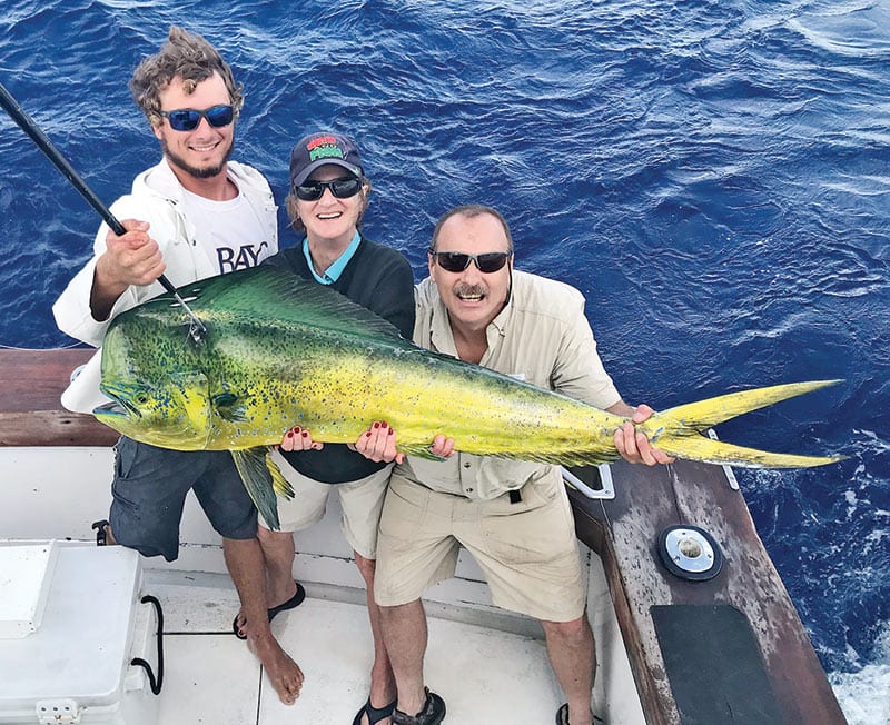 Alex, Pat and Dan with a monster bull dolphin caught fishing with Fishing Headquarters.