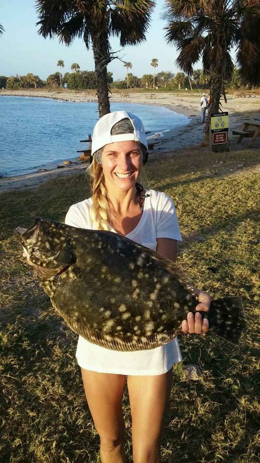 Katie Santure with a 6.7-pound flounder caught with an Alvey reel at the Sebastian Inlet. Photo credit: Warrick Smith.