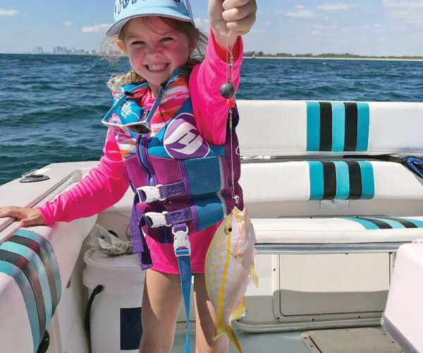 Six-year-old Cambree with her first yellowtail snapper.