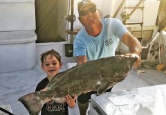 Capt Rod and Jayden with a nice black grouper.