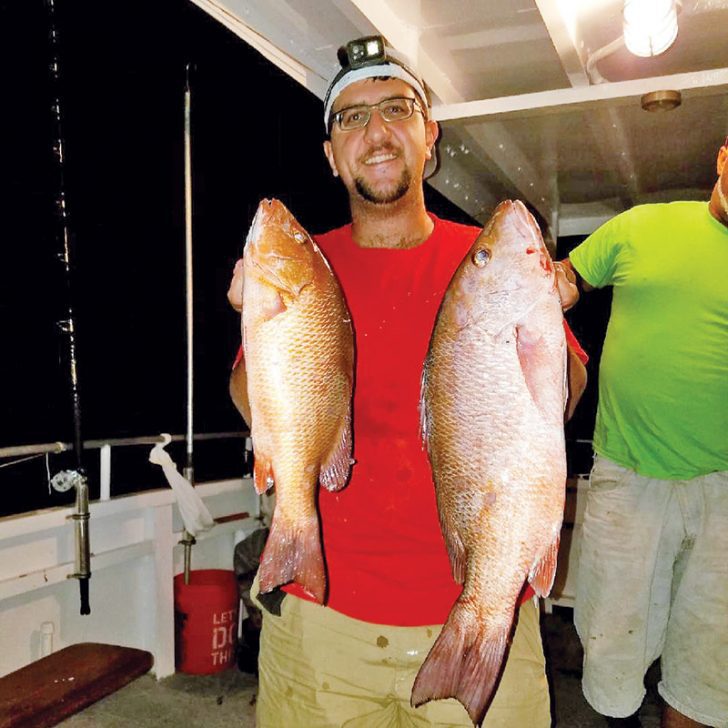 Chris with a pair of nice mangrove snappers caught with Fishing Headquarters.
