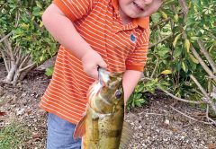 Four year old Bryce Sporrer with his first peacock bass.