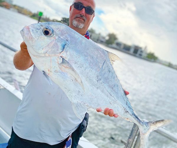 Lucky angler with a tasty African pompano caught aboard the Catch My Drift.
