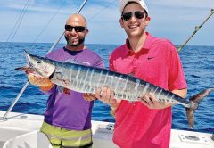 Fishing Headquarters' Bobby and a happy angler holding a nice wahoo.