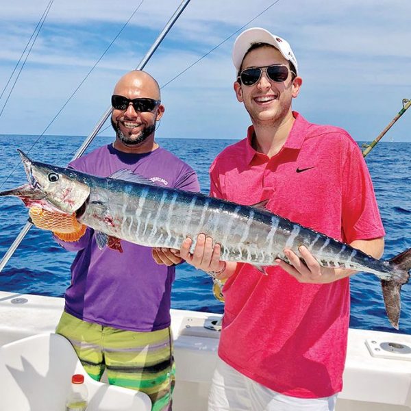 Fishing Headquarters' Bobby and a happy angler holding a nice wahoo.