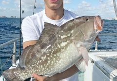 Frank with a nice red grouper aboard the Catch My Drift.