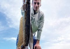 Josh Patrick with a Tamarac snakehead caught on an artificial frog.