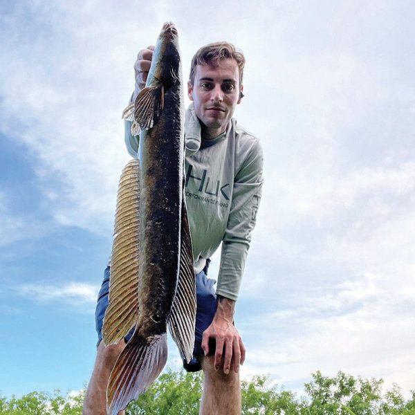 Josh Patrick with a Tamarac snakehead caught on an artificial frog.