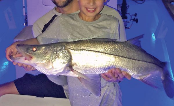 Capt. Ryan put this young angler on his first snook.