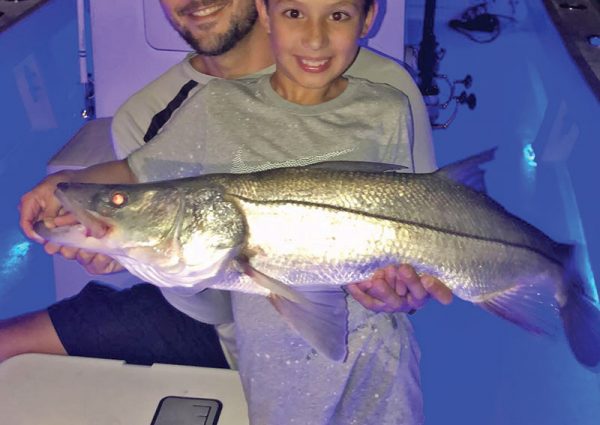 Capt. Ryan put this young angler on his first snook.