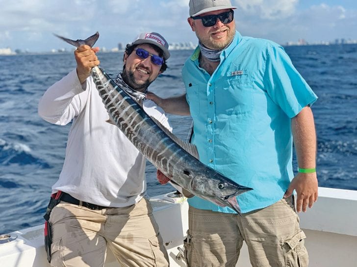 Chris with a lit up wahoo caught with New Lattitude Sportfishing.