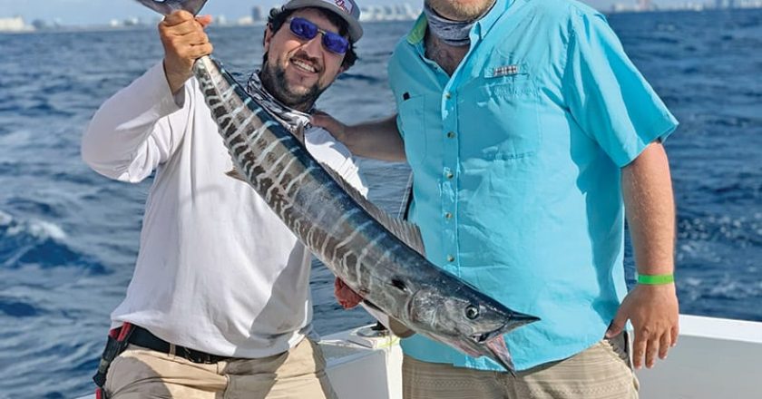 Chris with a lit up wahoo caught with New Lattitude Sportfishing.