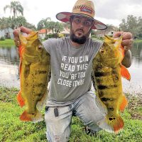 Tym Walker aka @kaya_mystic_daddy with a pair of quality peacock bass.