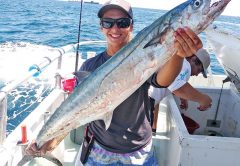 Kaylee with a monster kingfish caught aboard the Catch My Drift.
