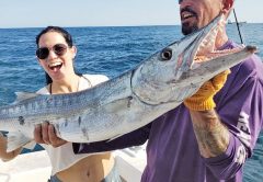 Kristine and Mick with a big Barracuda caught aboard the New Lattitude.