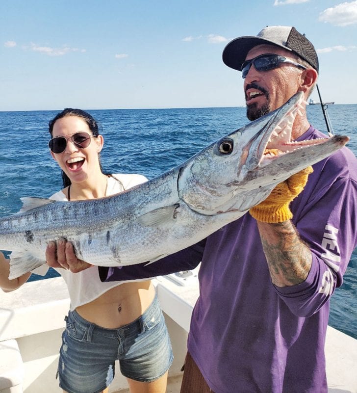 Kristine and Mick with a big Barracuda caught aboard the New Lattitude.