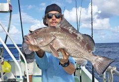 Kyle with a nice red grouper caught drift fishing aboard the 'Catch My Drift.'