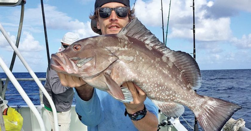 Kyle with a nice red grouper caught drift fishing aboard the 'Catch My Drift.'