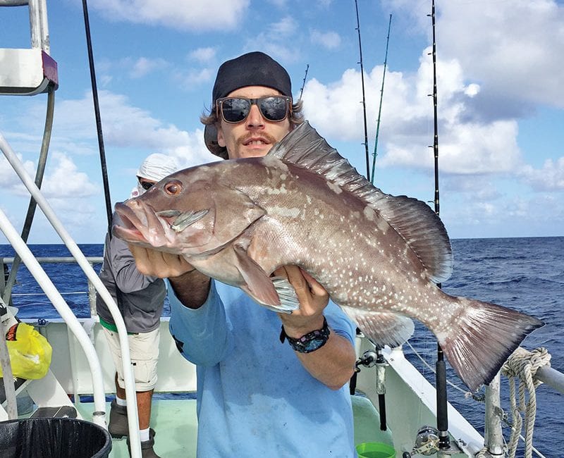 Kyle with a nice red grouper caught drift fishing aboard the 'Catch My Drift.'