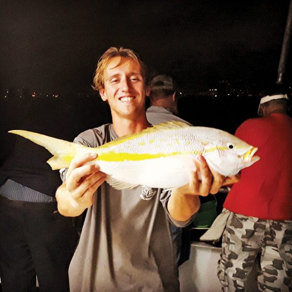 Matt with a nice yellowtail he caught night fishing on Catch My Drift.