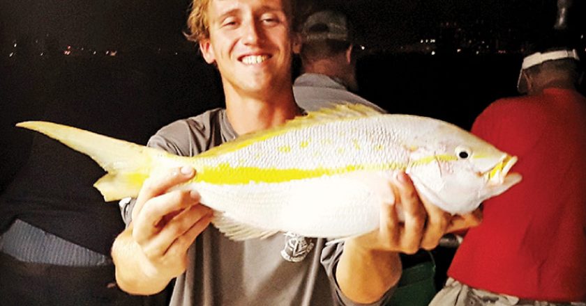 Matt with a nice yellowtail he caught night fishing on Catch My Drift.