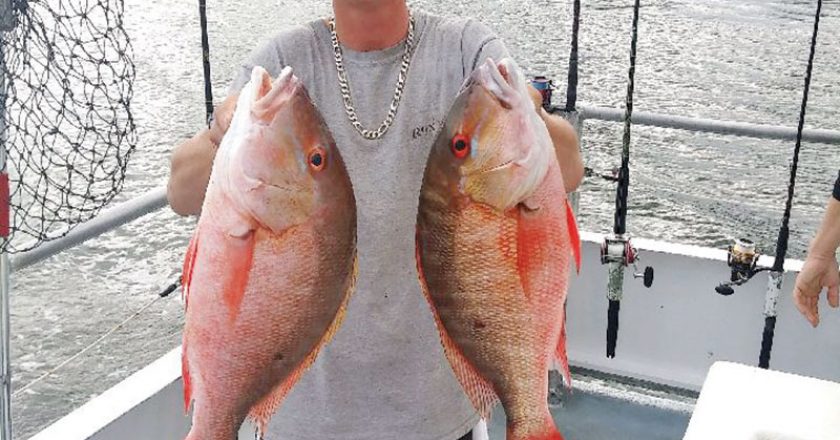 Matt with a pair of nice mutton snapper caught on the Catch My Drift.