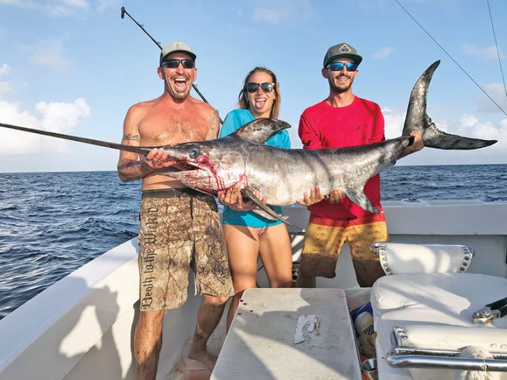 Mick, Kaylee and Nick with a nice swordfish caught with Fishing Headquarters.