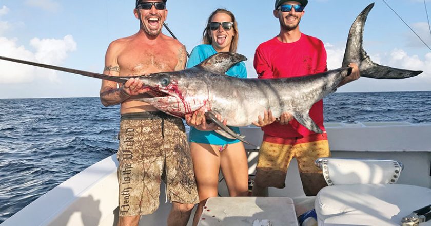 Mick, Kaylee and Nick with a nice swordfish caught with Fishing Headquarters.