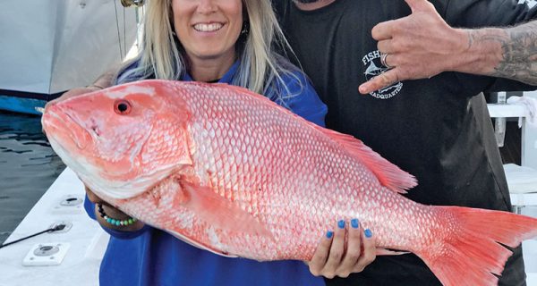 Mick and Michelle with a giant Red Snapper caught with Fishing Headquarters.