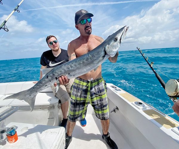 Mick with a big barracuda caught with New Lattitude Sportfishing.