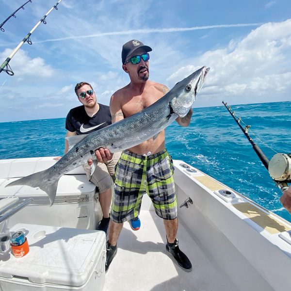 Mick with a big barracuda caught with New Lattitude Sportfishing.