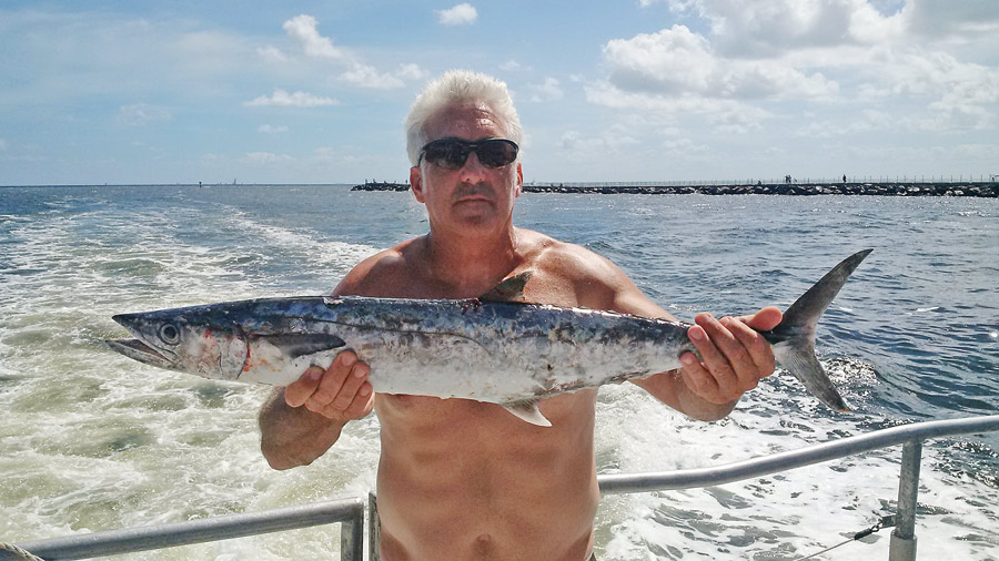 Pat with a nice kingfish caught drift fishing with Fishing Headquarters.