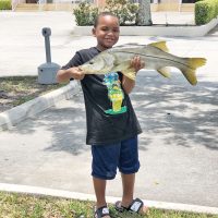 Seven-year-old Sandro Toruno with a very respectable freshwater snook.