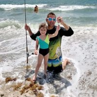 Five year old Stella and her proud dad Rob with her first catch ever, a palometa.