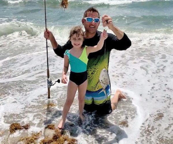 Five year old Stella and her proud dad Rob with her first catch ever, a palometa.