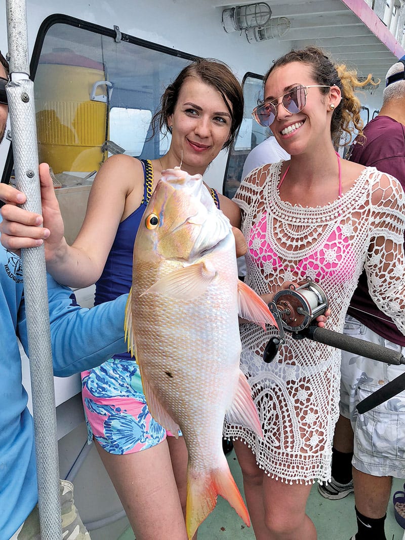 These gals caught a nice mutton snapper aboard the Catch My Drift.