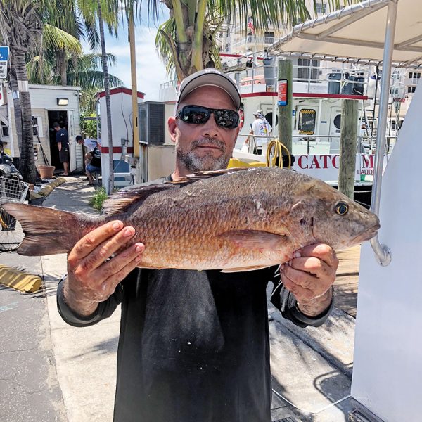 Waylan with a big mangrove snapper he caught on the Catch My Drift.