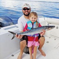 Four year old Caylee Dyer caught her first kingfish with a little help from her dad.