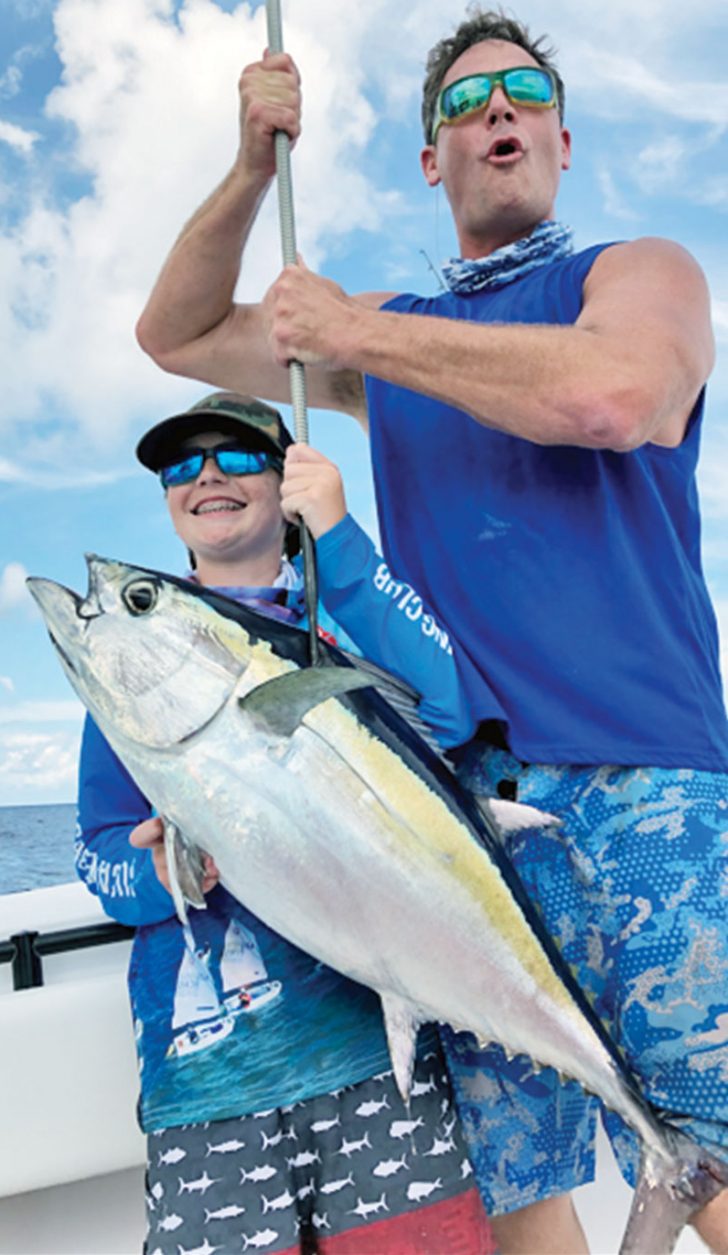 Finn Wilkening, 12, caught this 25 pound blackfin tuna to secure