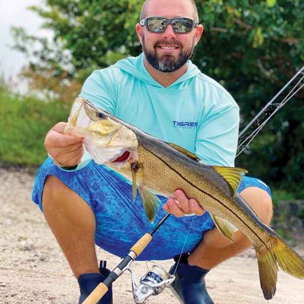 Capt. Mark DiDario with a snook caught on the freshwater side of a local spillway.