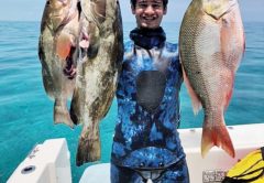 Mikey Rose with a pair of opening day grouper and a mutton snapper.