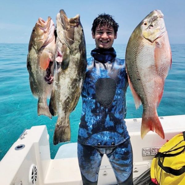 Mikey Rose with a pair of opening day grouper and a mutton snapper.